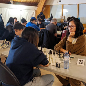 Two people playing chess in a tournament.